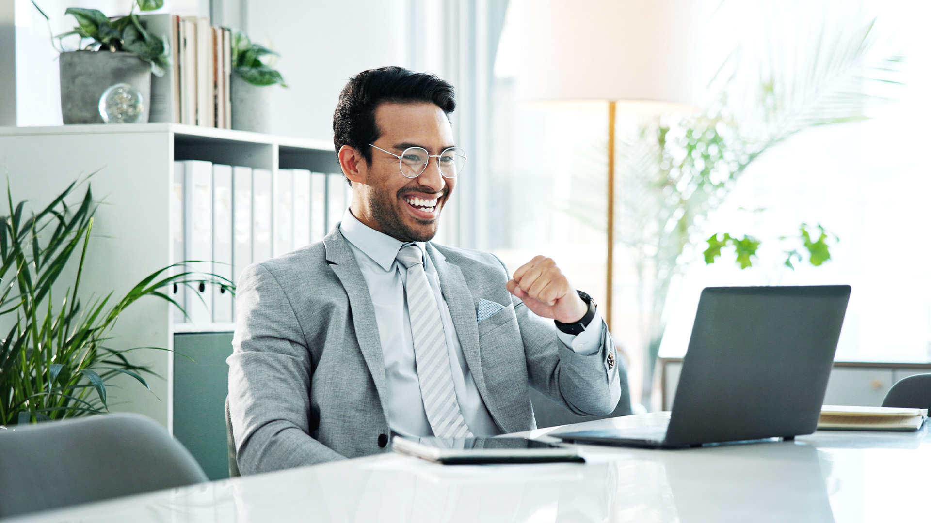 Business man using a laptop to complete CRE forecasts